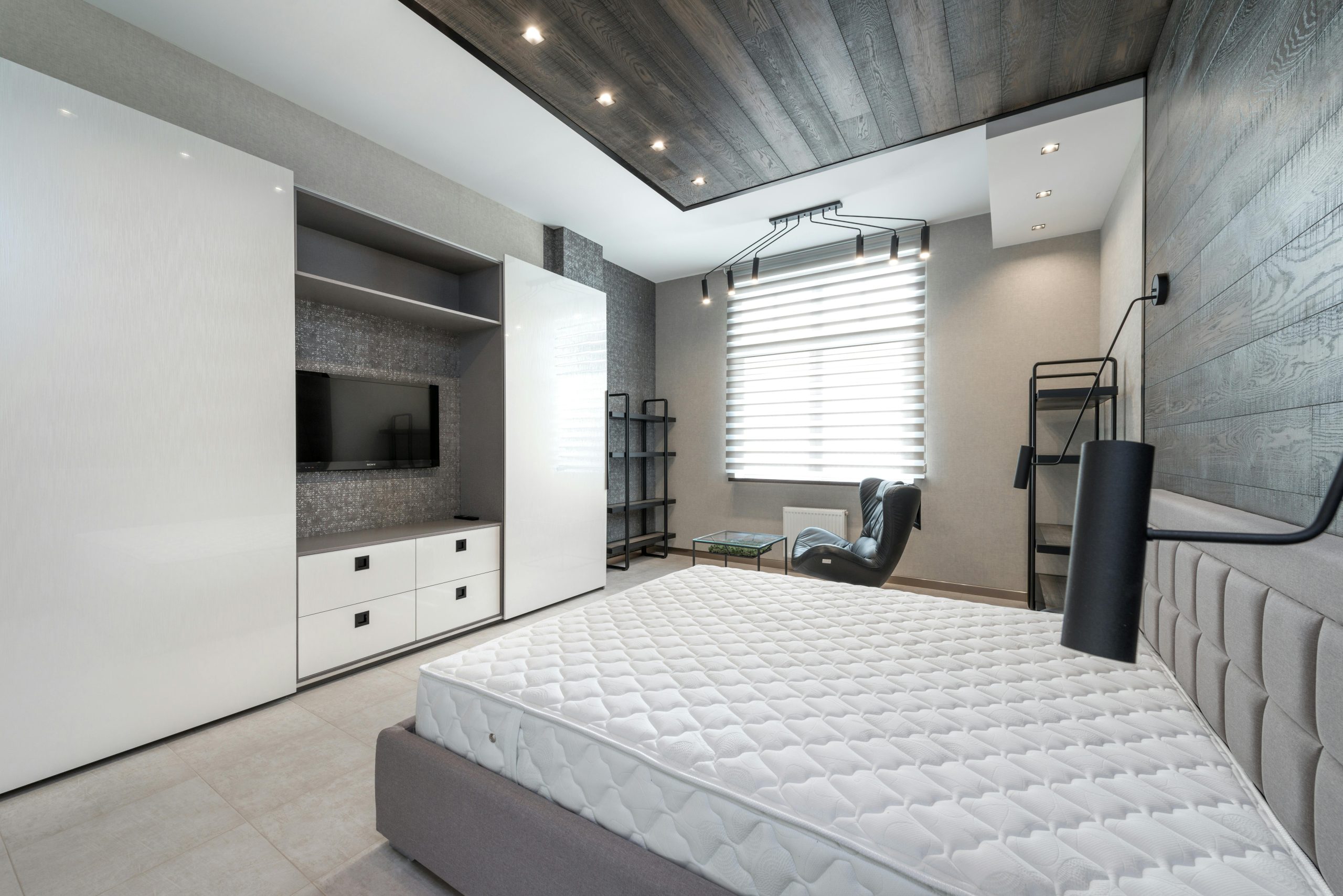 Home Elegant and spacious modern bedroom with minimalist decor and neutral color palette.