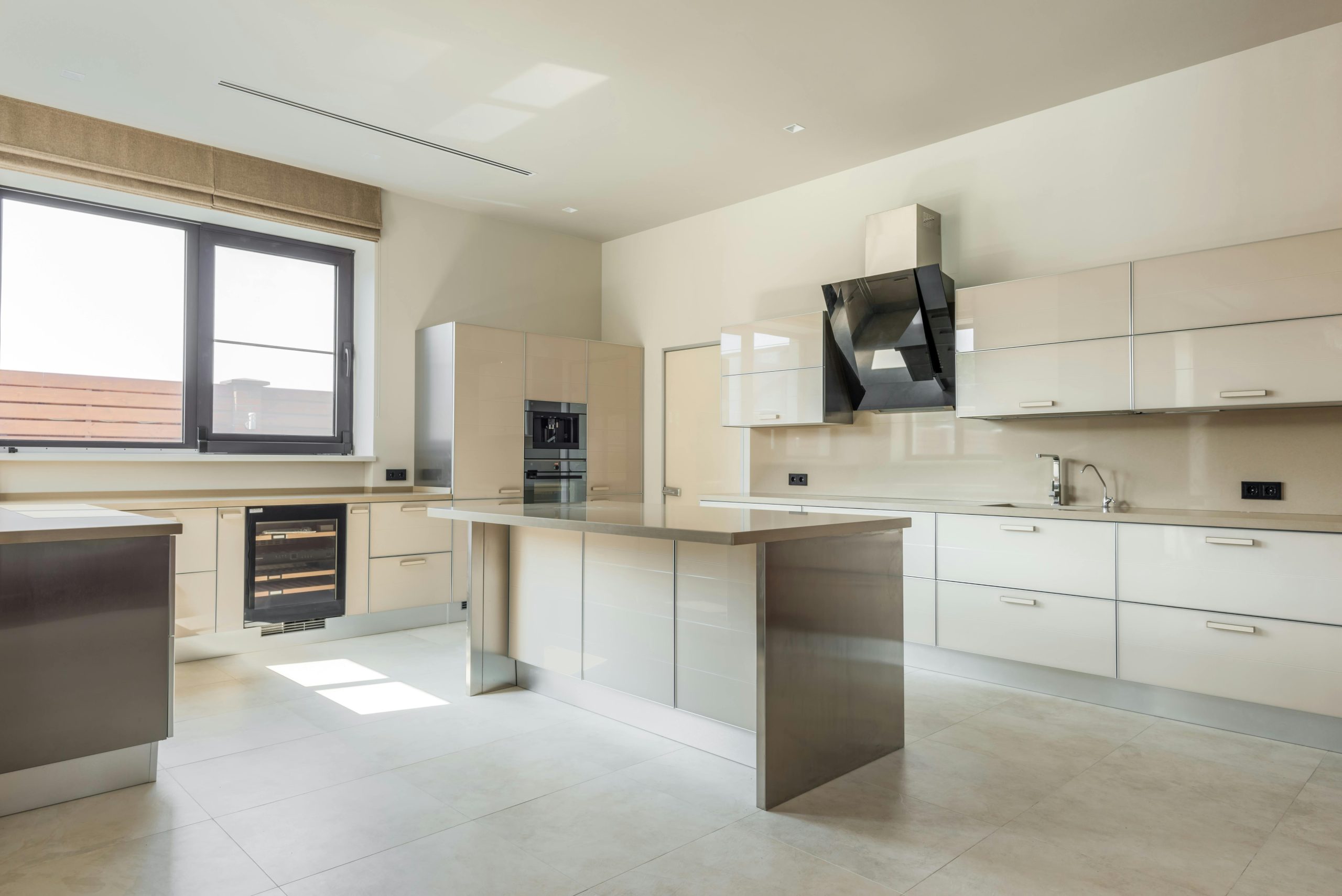 Home A bright, spacious kitchen featuring minimalist design and modern appliances.
